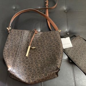 Calvin Klein purse and wallet attached. Tags attached. Never worn, new.